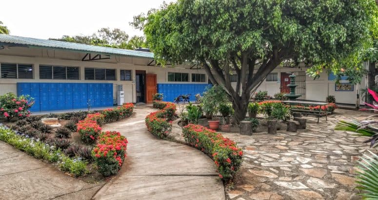 Courtyard at Nicaragua Christian Academy, with student lockers and a garden path